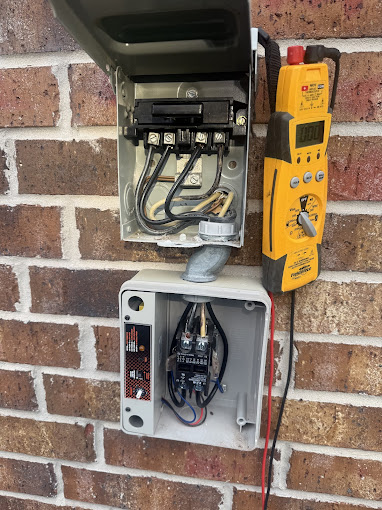 Texas Heatwave technician checking electrical readings with a clamp meter during an HVAC maintenance tune-up