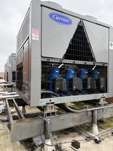 Large commercial Carrier chiller unit on a rooftop, the kind of system Texas Heatwave services on emergency calls