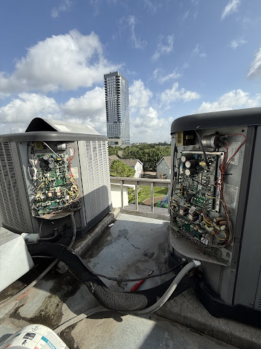 Texas Heatwave technician servicing rooftop AC condensing units with the Houston skyline in the background
