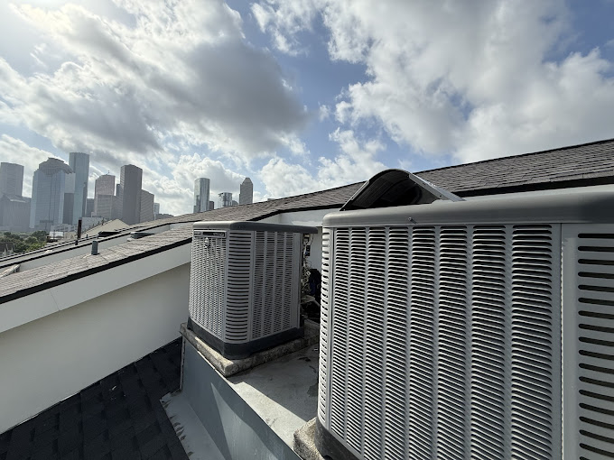 Texas Heatwave rooftop air conditioning condenser serviced against the Houston skyline