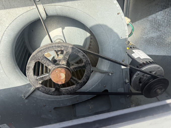 Texas Heatwave AC and Heating technician servicing an HVAC blower assembly during a maintenance visit in The Woodlands, TX